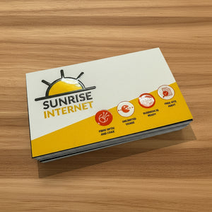 Sunrise Internet business cards on a timber surface